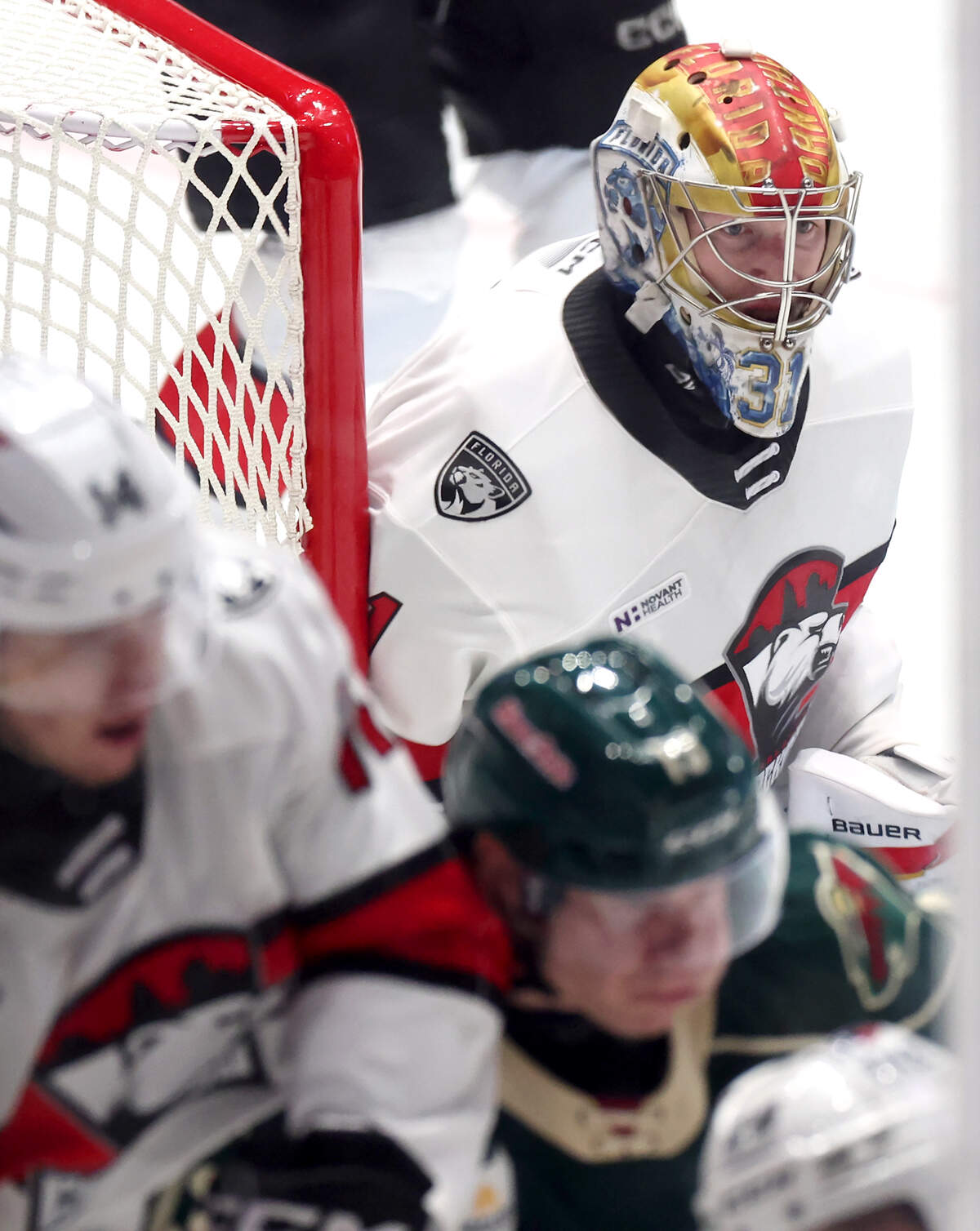 Charlotte Checkers goalie Cooper Black, right, watches the movement of the puck during third period action against the Iowa Wild on Friday, October 17, 2025 at Bojangles Coliseum in Charlotte, NC.