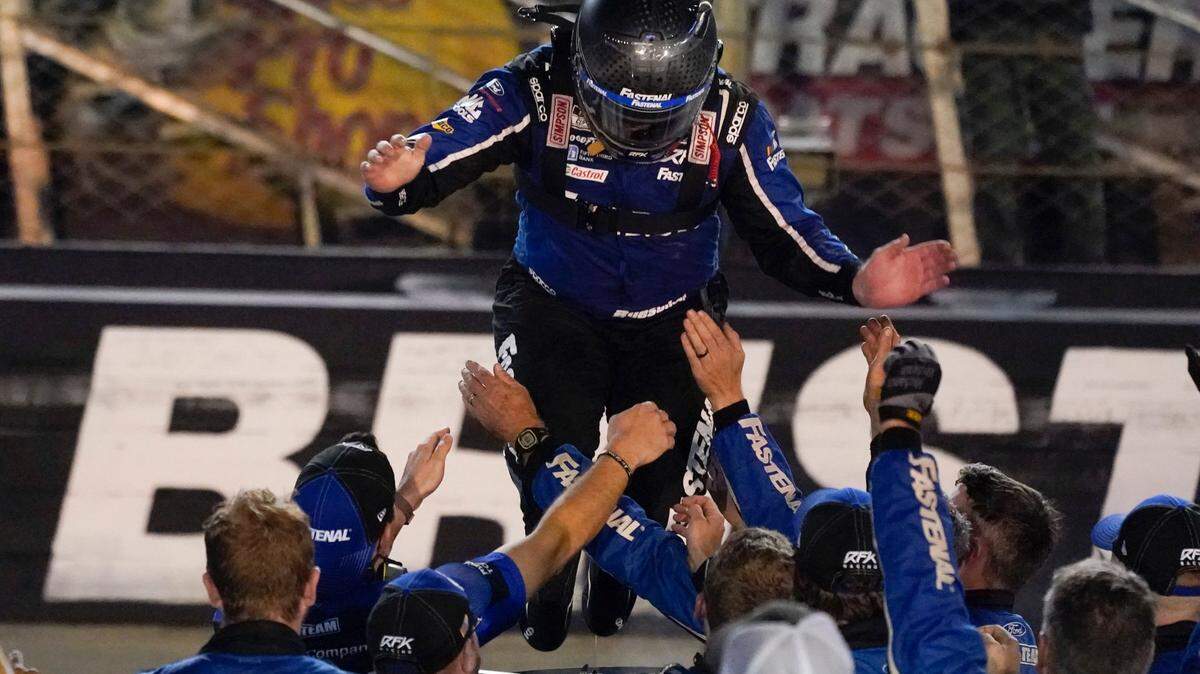 Chris Buescher jumps from the top of his car to the arms of his crew after winning a NASCAR Cup Series auto race at Bristol Motor Speedway Saturday, Sept. 17, 2022, in Bristol, Tenn. (AP Photo/Mark Humphrey)