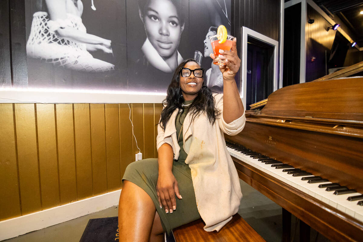 Patrice Jennings, owner of Harlem Nights Restaurant, paid homage to her mother by adding her to likeness to the mural behind her.