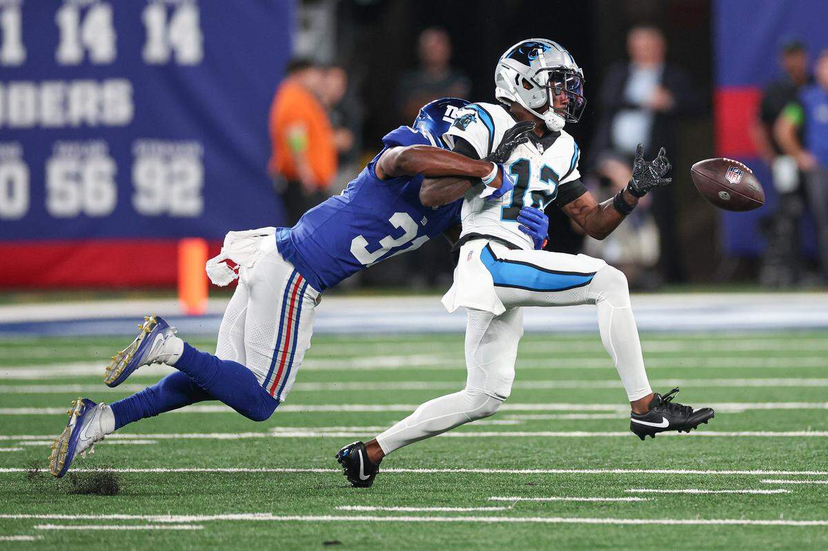 Aug 18, 2023; East Rutherford, New Jersey, USA; New York Giants safety Gervarrius Owens (31) breaks up a pass intended for Carolina Panthers wide receiver Shi Smith (12) during the first half at MetLife Stadium. Mandatory Credit: Vincent Carchietta-USA TODAY Sports