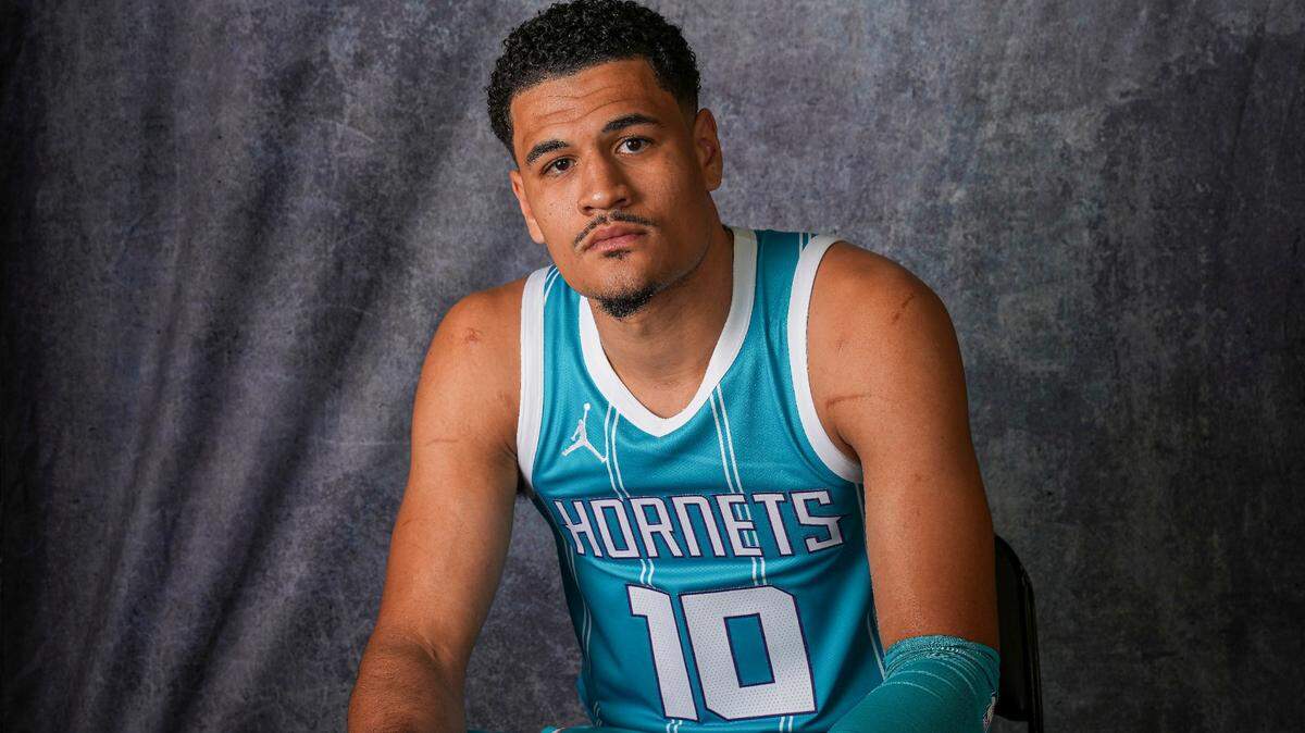 Charlotte Hornets guard Josh Green (10) poses for photos at Charlotte Hornets media day on Monday.