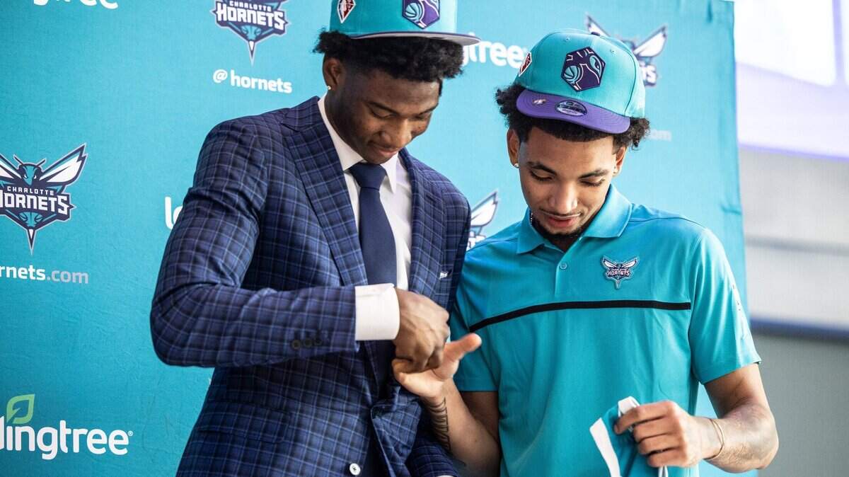 Charlotte Hornets draft picks, Kai Jones, left, and James Bouknight, shake hands during a press conference at the Spectrum Center in Charlotte, N.C., on Friday, July 30, 2021.