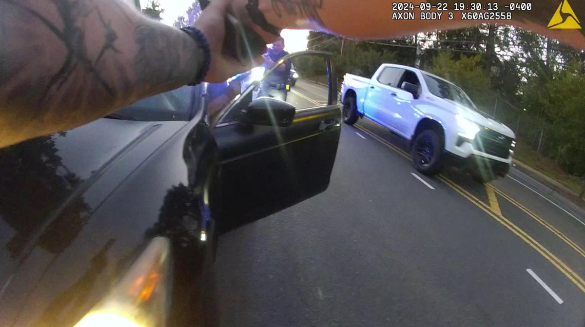 An image from police body-camera video shows Nerin Funez-Reyes pointing a gun from inside the car at Charlotte-Mecklenburg Police Department Officer Kenneth Kludy.