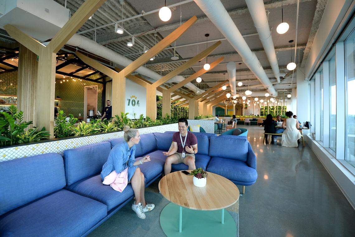 Credit Karma employees sit April 13 in the lounge and cafe area on the 10th floor at the company’s new Ballantyne Corporate office in Charlotte.