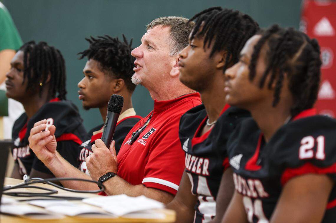 Head football coach for Butler High School, Brian Hales, center, answers questions during the Southwestern 4A conference media day on Thursday, July 28, 2022 in Charlotte, NC.