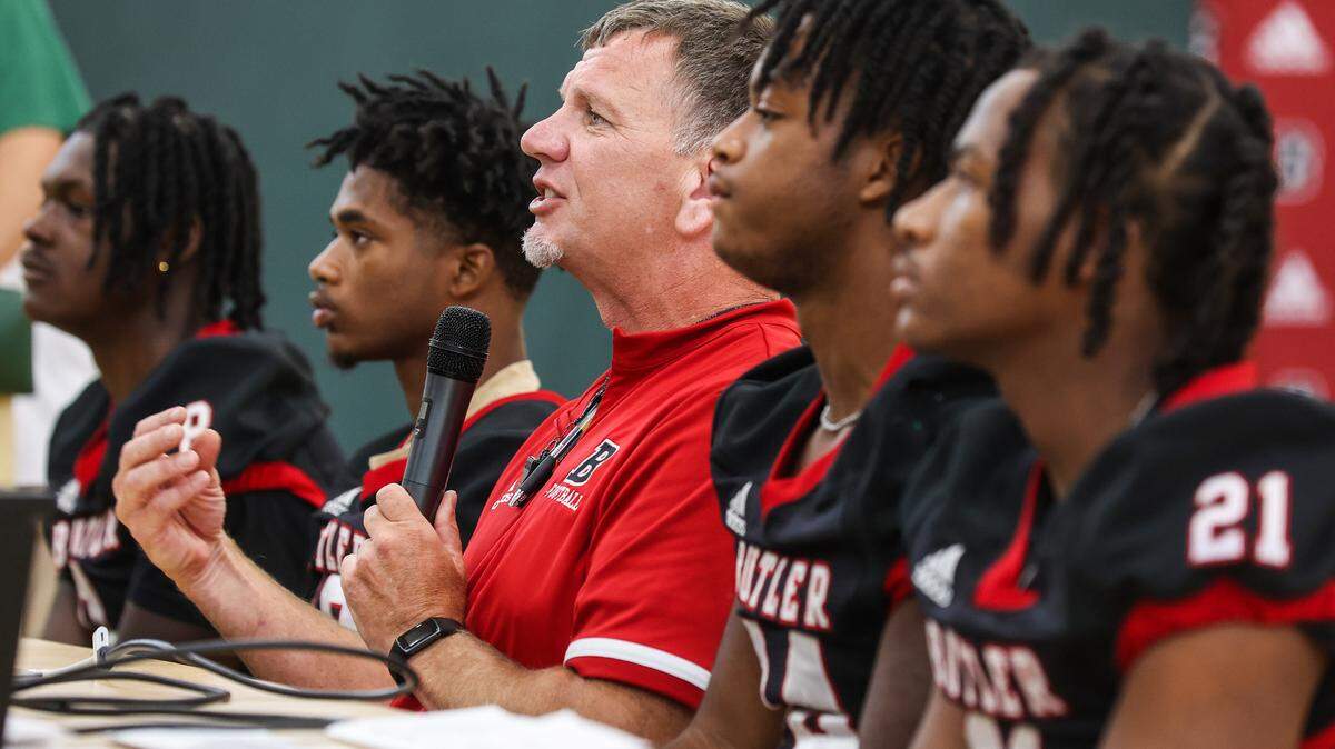 Head football coach for Butler High School, Brian Hales, center, answers questions during the Southwestern 4A conference media day on Thursday, July 28, 2022 in Charlotte, NC.