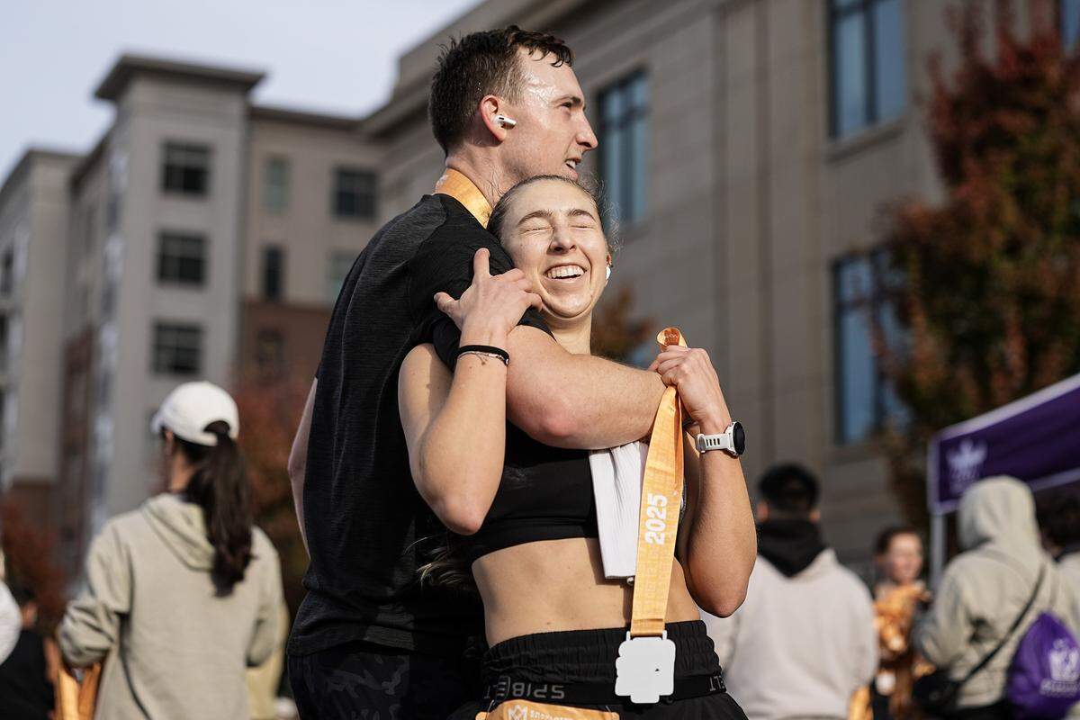 Participants embrace after competing in the Novant Health Charlotte Marathon Saturday, Nov. 15, 2025, in Charlotte, N.C.