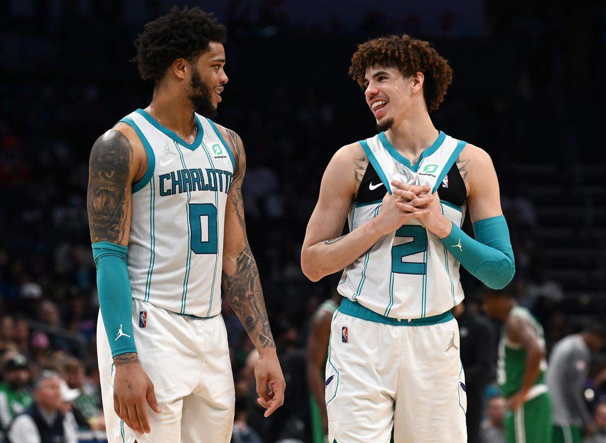 Charlotte Hornets forward forward Miles Bridges, left and guard LaMelo Ball, right, talk during a timeout against the Boston Celtics at Spectrum Center in Charlotte, NC on Wednesday, March 9, 2022. The Celtics defeated the Hornets 115-101.
