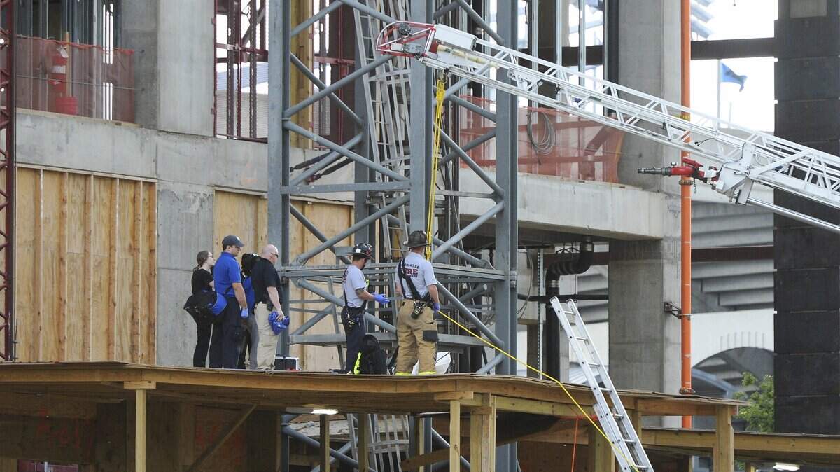 Investigators observe the scene of a death in a fall at an uptown Charlotte office building under construction,  part of the Legacy Union development, on the former Charlotte Observer site on Wednesday, May 23, 2018.