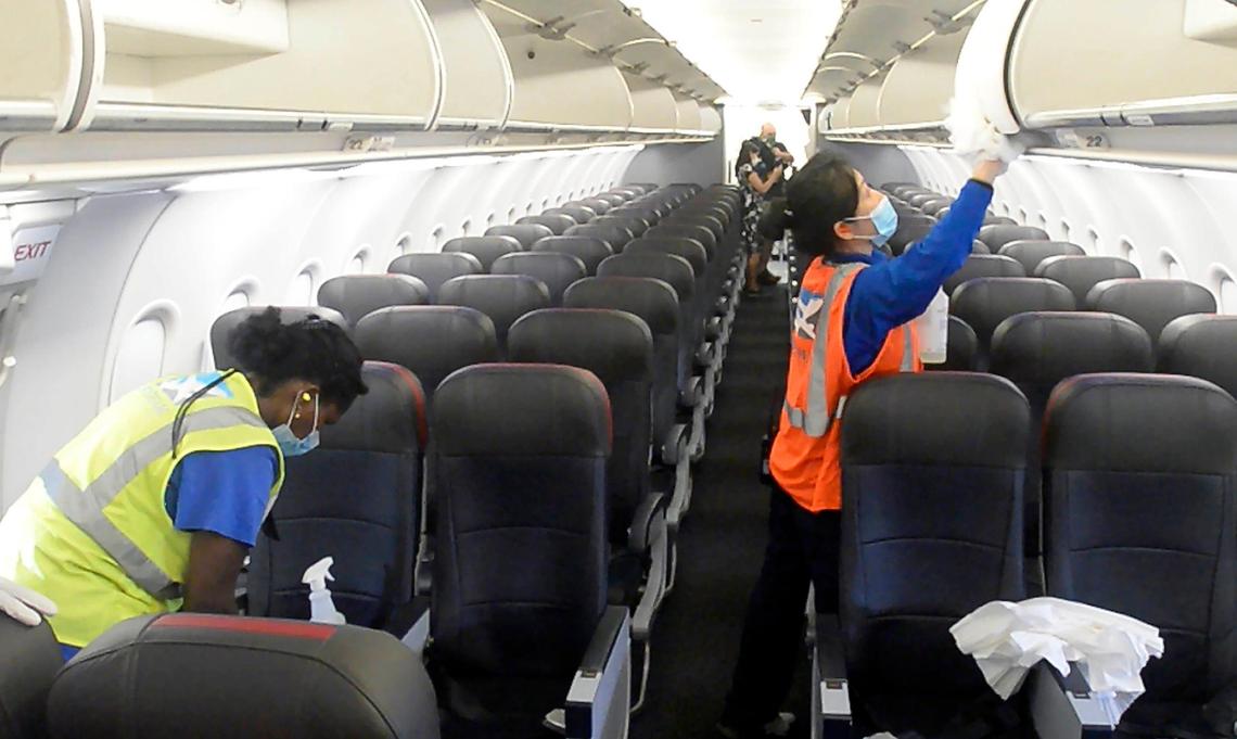 Airplane cleaners disinfect the cabin area of an American Airlines jet during the turnaround phase of the plane at Charlotte Douglas International Airport on Tuesday, June 30, 2020. American Airlines, the dominant air carrier at the airport, invited the media to watch an on-board demonstration of their aircraft cleaning process to show the expanded cleaning of the airplanes.