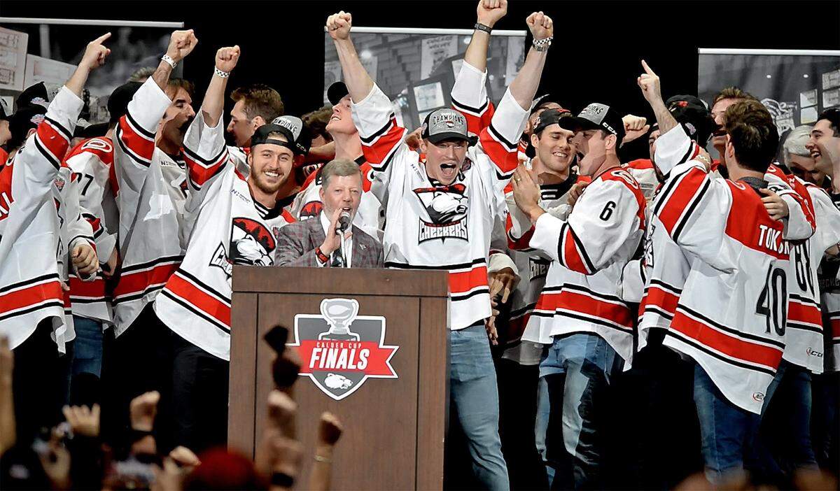The Charlotte Checkers celebrate their winning the Calder Cup with team owner Michael Kahn, at microphone, and fans at Bojangles’ Coliseum in Charlotte on June 10, 2019.