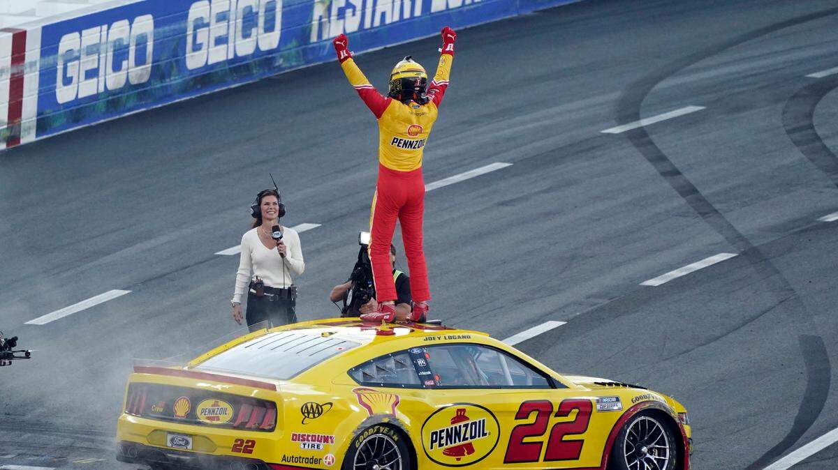 Joey Logano celebrates at the start/finish line after winning a NASCAR exhibition auto race at Los Angeles Memorial Coliseum, Sunday, Feb. 6, 2022, in Los Angeles. (AP Photo/Marcio Jose Sanchez)