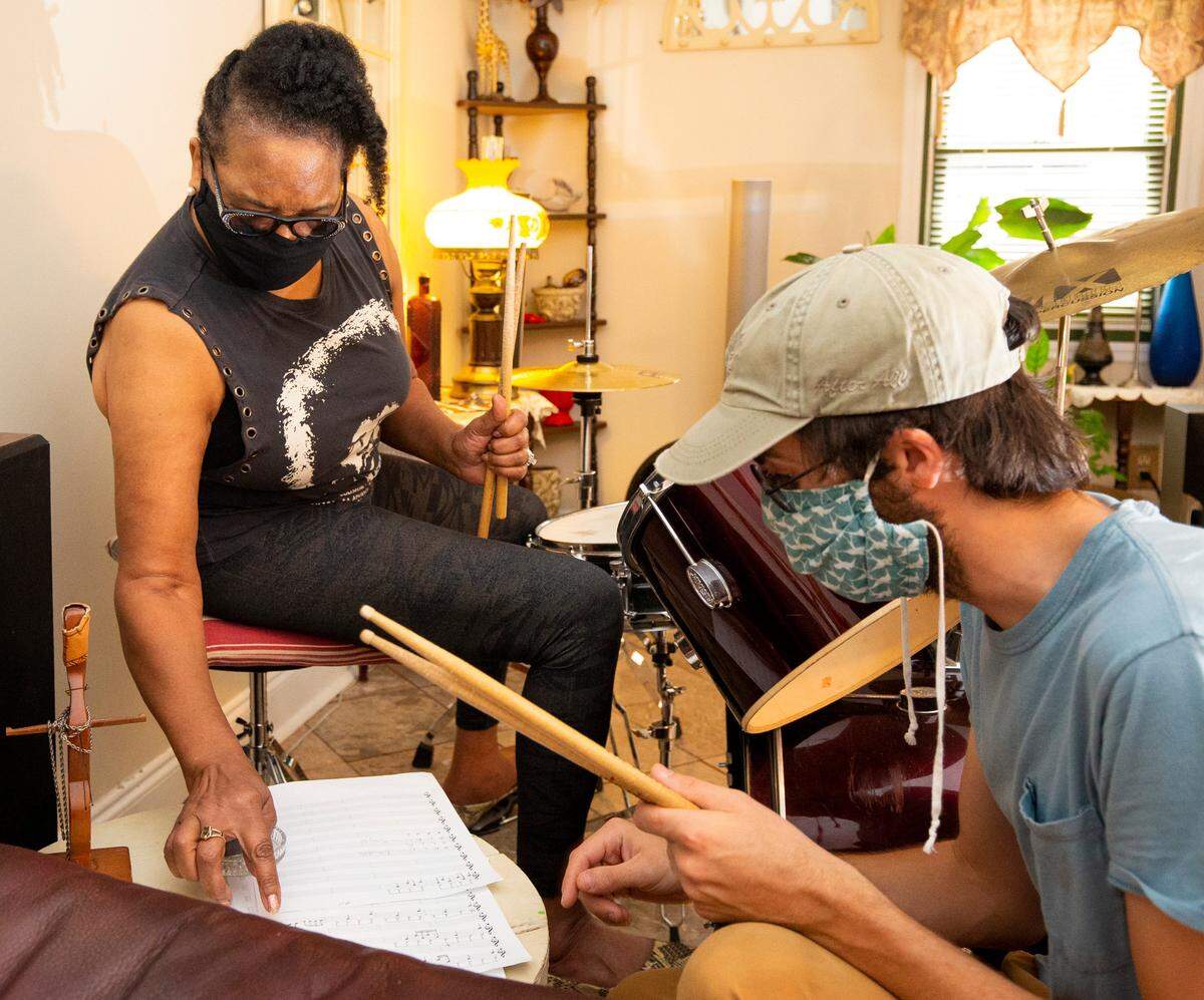 Alvesta Cody questions instructor Ryan Colebeck about sheet music during a drum lesson at her Charlotte home. When COVID-19 canceled Cody's group activities for seniors, she decided at age 70 to learn to the play the drums.