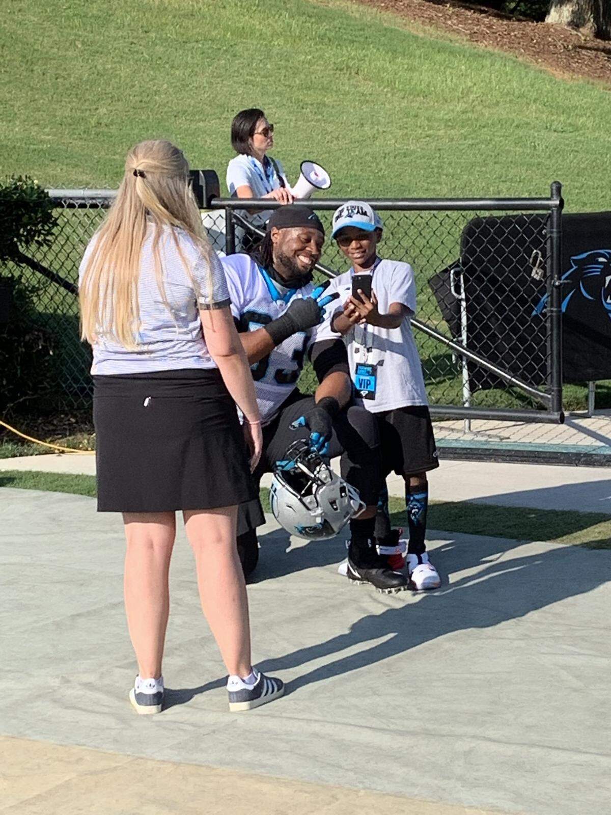 New Carolina Panthers defensive lineman Gerald McCoy takes time for a selfie with a young fan before the team’s first practice of training camp on Thursday, July 25, 2019 at Gibbs Stadium on the campus of Wofford College in Spartanburg, S.C.