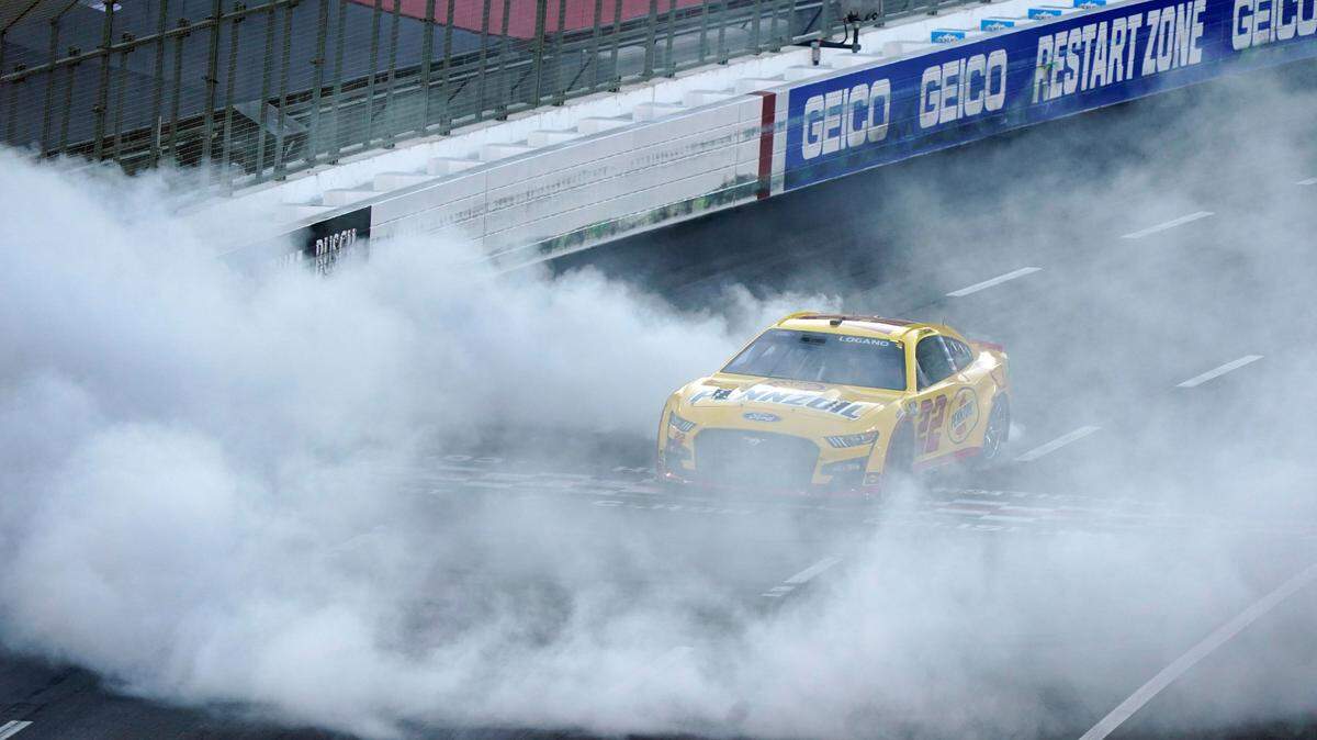 Joey Logano does a burnout at the start/finish line after winning a NASCAR exhibition auto race at Los Angeles Memorial Coliseum, Sunday, Feb. 6, 2022, in Los Angeles. (AP Photo/Marcio Jose Sanchez)