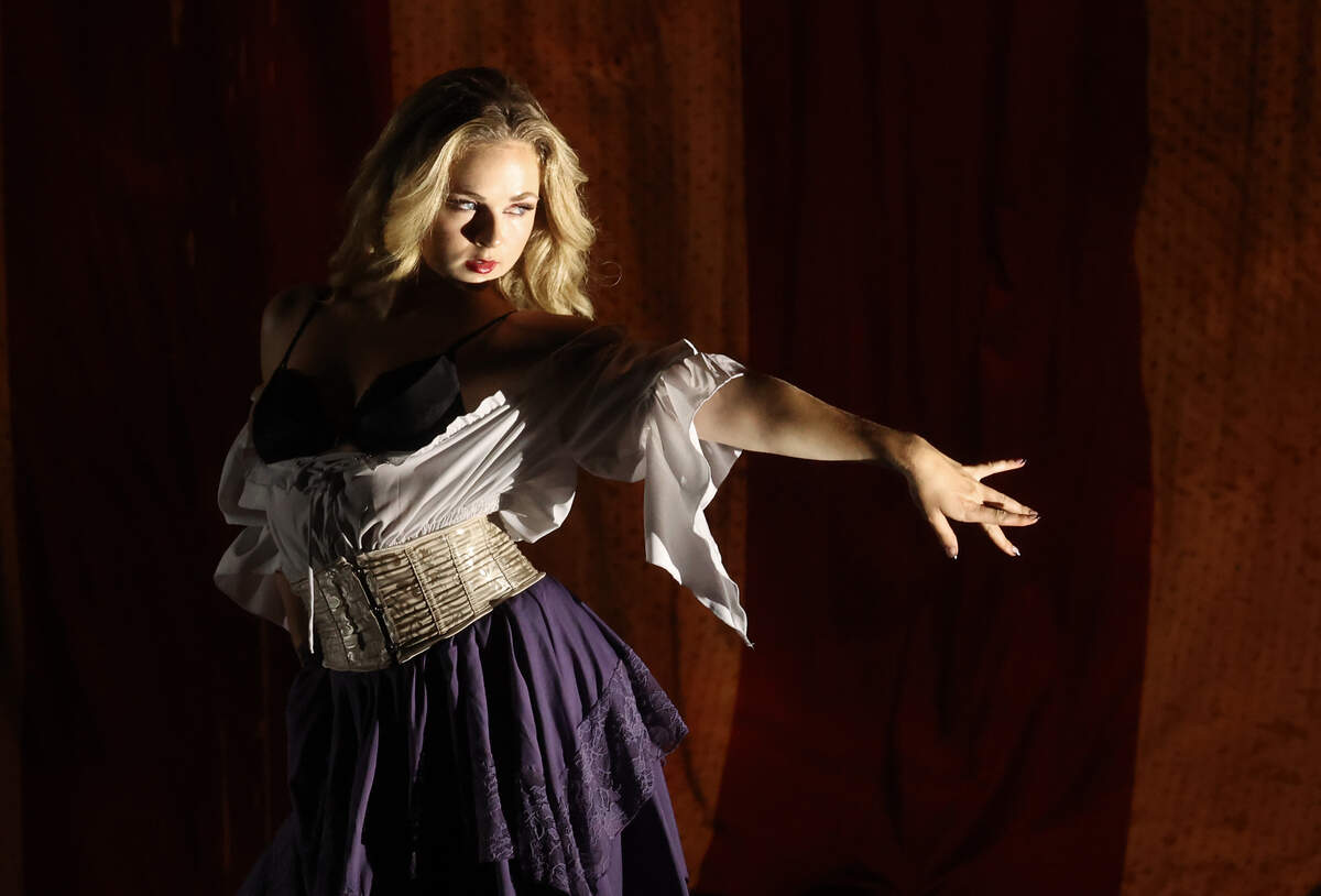 A dancer moves across the stage to entertain and welcome fans to Mötley Crüe’s “The Return of the Carnival of Sins” tour at Truliant Amphitheater in Charlotte on Monday night.