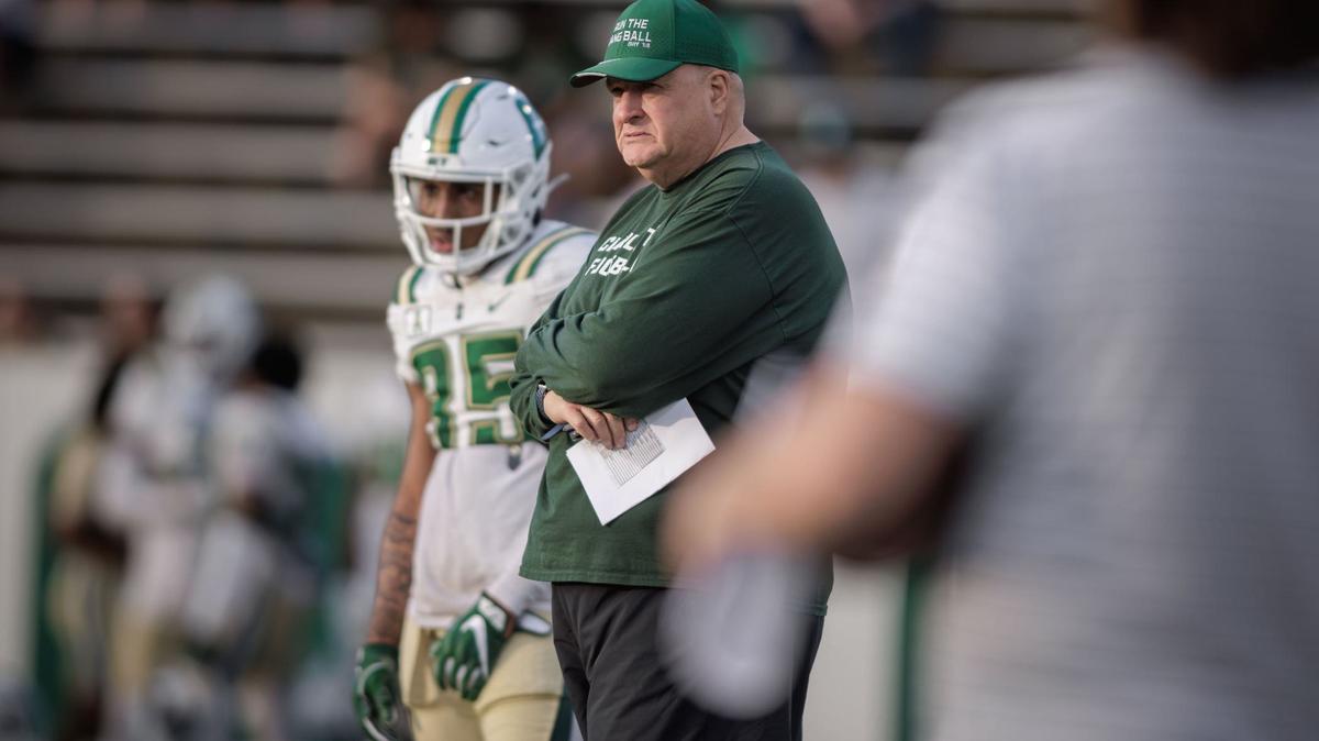 Charlotte Football head coach Biff Poggi (center) looks on as his team takes the field for the annual Green & White game at Jerry Richardson Stadium Saturday April 20th, 2024.