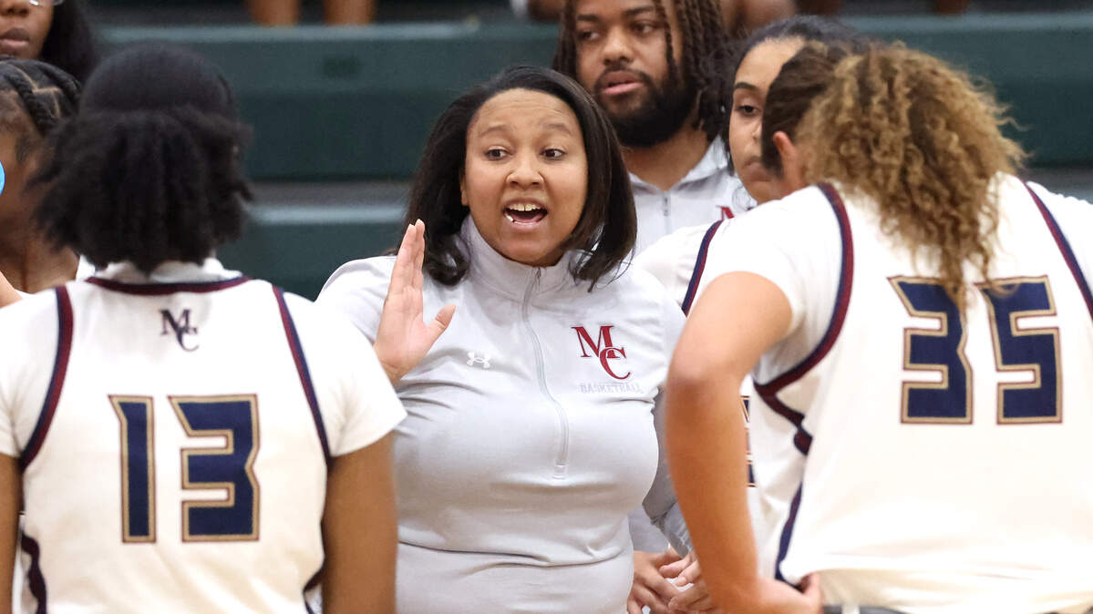 Mallard Creek head girls basketball coach Karlyn Dixon, center, gives instructions to her team during action against North Meck in the Power Six Conference Tournament action on Friday, February 20, 2026 at Independence High School.