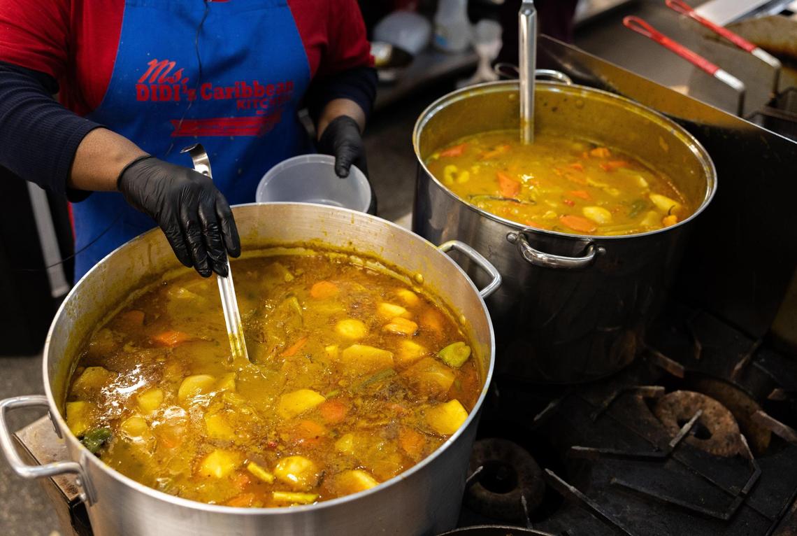 Owner of Ms. Didi’s, Edith Jean-Francois, stirs a pot of soup joumou in Charlotte, N.C., on Tuesday, December 31, 2024.