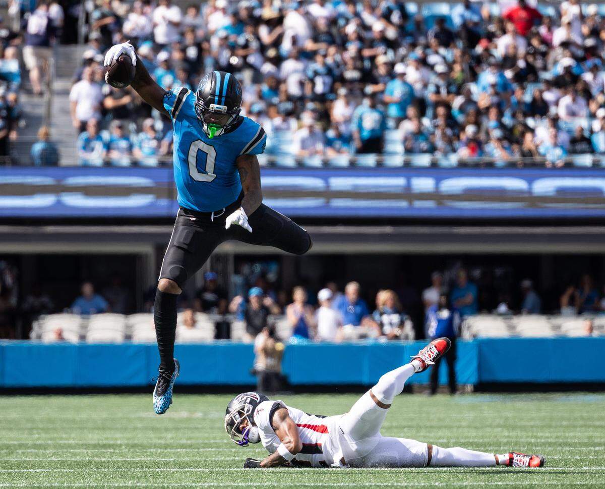 Carolina Panthers JaiTavion Sanders, top, leaps over Atlanta Falcons cornerback Mike Hughes on Sept. 21.