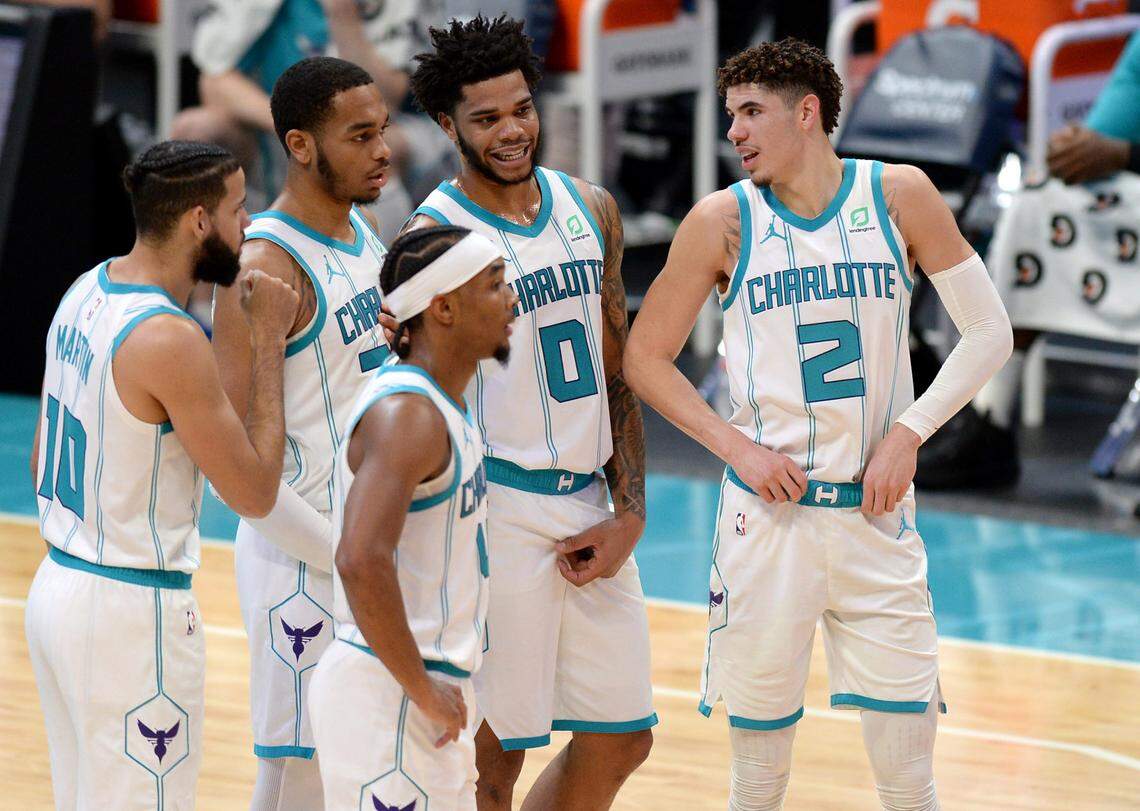 Members of the Charlotte Hornets converse with LaMelo Ball (2). The Hornets are playing in front of empty arenas in Charlotte due to COVID-19 protocols and will do so for the immediate future.