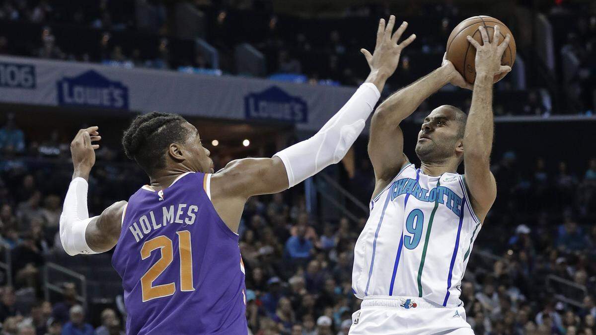 Charlotte point guard Tony Parker, right, defended by the Phoenix Suns’ Richaun Holmes, had 14 points and four assists in the Hornets 135-115 victory on Saturday.