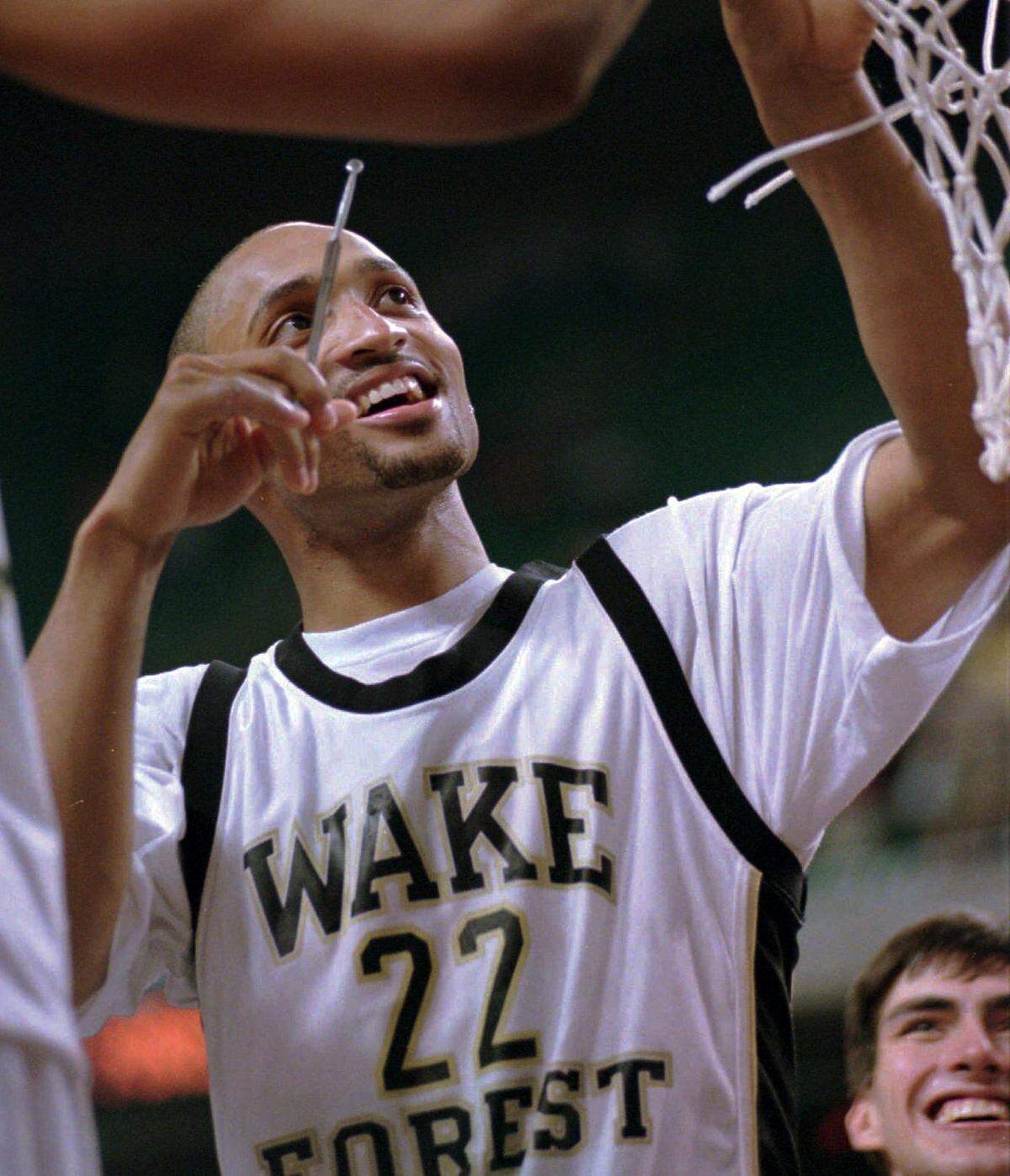 3/13/95 1A CHRISTOPHER A. RECORD/Staff Wake Forest guard Randolph Childress is all smiles as he cuts down the net after an 82-80 victory over the North Carolina Tar Heels Sunday at Greensboro Coliseum. [UNPUBLISHED:] Wake Forest guard Randolph Childress is all smiles as he prepares to cut down the net following their victory over the UNC Tar Heels Sun. in the Men’s ACC Tournament game in Greensboro, NC. Photo By: Christopher A. Record/Staff