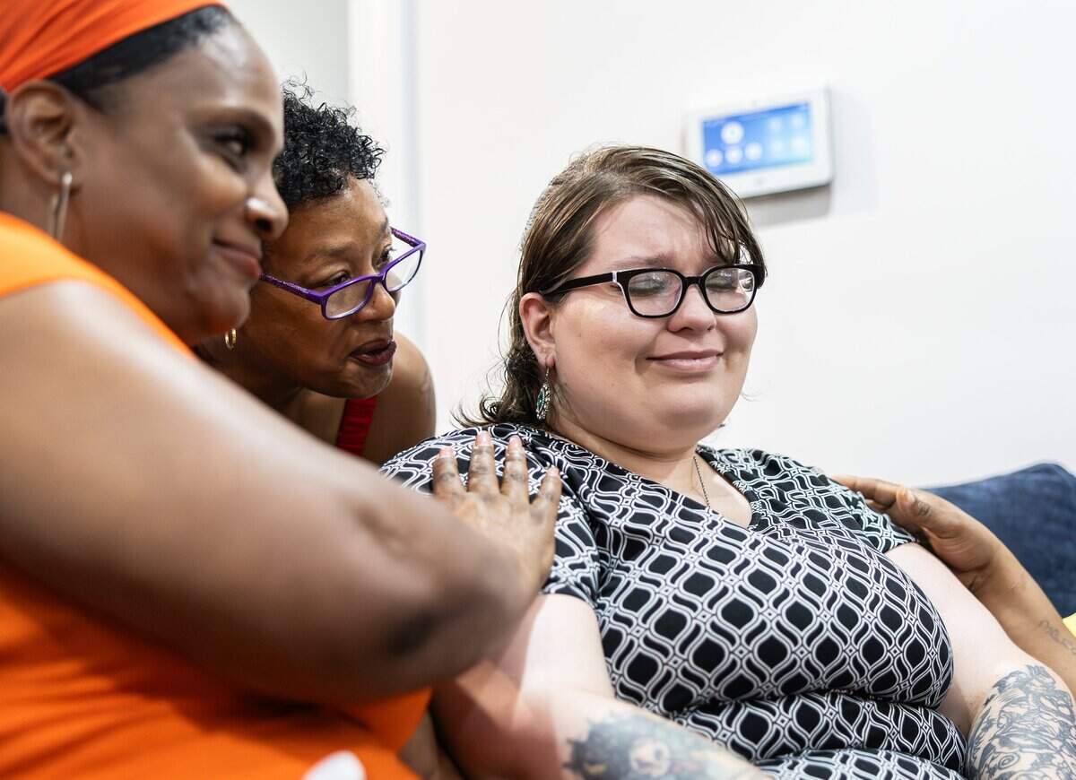 Sage Jones, right, is comforted after she became emotional sharing her story during the grand opening of A New Way of Life, a reentry home for formerly incarcerated women in Charlotte.