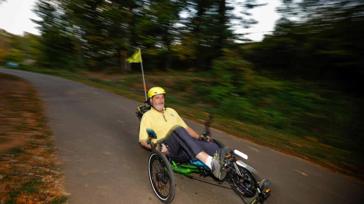 Alan Sussman rides a recumbent bicycle on the Little Sugar Creek Greenway through Park Road Park in Charlotte. In 2015, Sussman was riding his bike a few miles from his uptown home when he was struck by a vehicle, causing spinal cord and hip injuries. During his recovery, which left him in a wheelchair, he frequently relied on buses and light rail to get around.