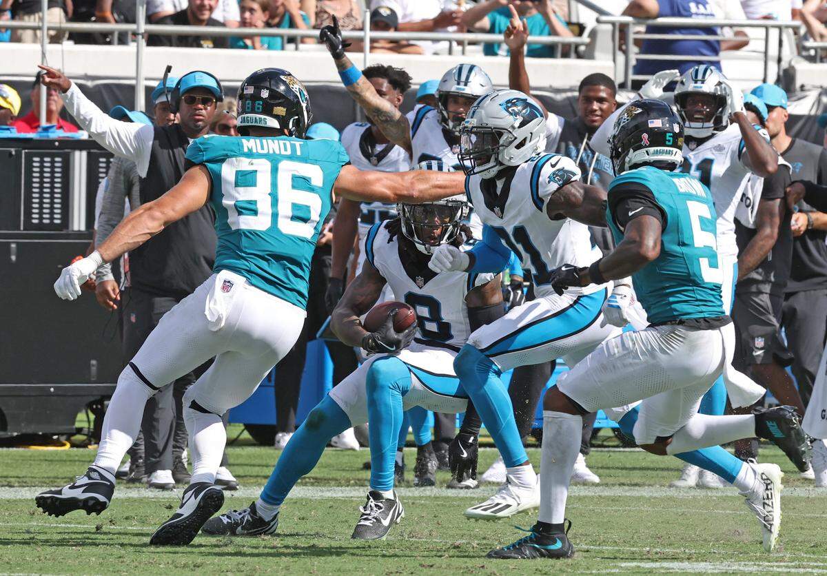 Carolina Panthers cornerback Jaycee Horn, center, intercepts a pass by Jacksonville Jaguars quarterback Trevor Lawrence during action on Sunday, September 7, 2025 at Everbank Stadium in Jacksonville, Florida. The Jaguars defeated the Panthers 26-10.