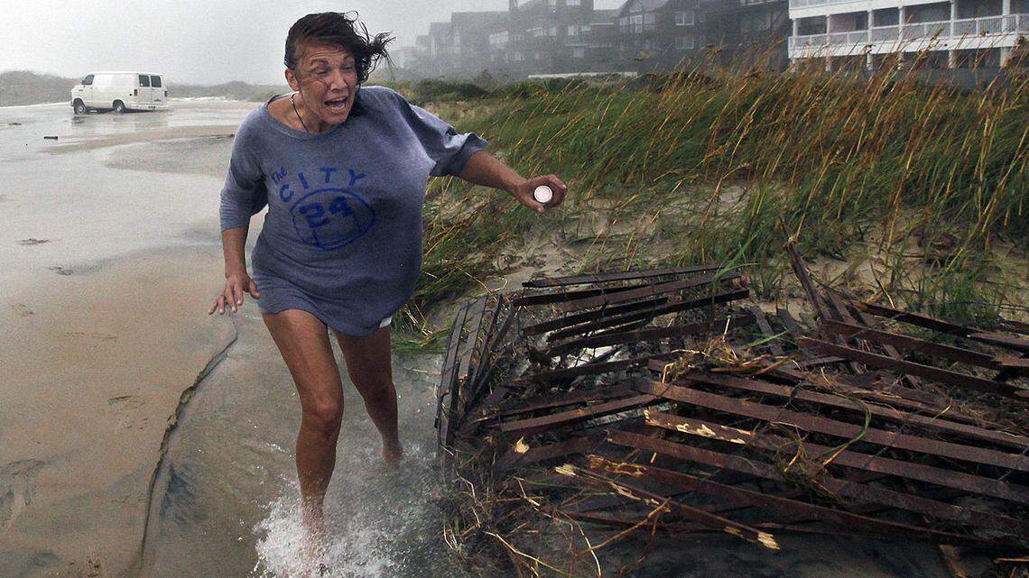 Jackie Sparnackel abandons her van and her belongings near the Frisco Pier after overwash stranded her vehicle as the wind and rain of Hurricane Irene batters the Outer Banks in 2011