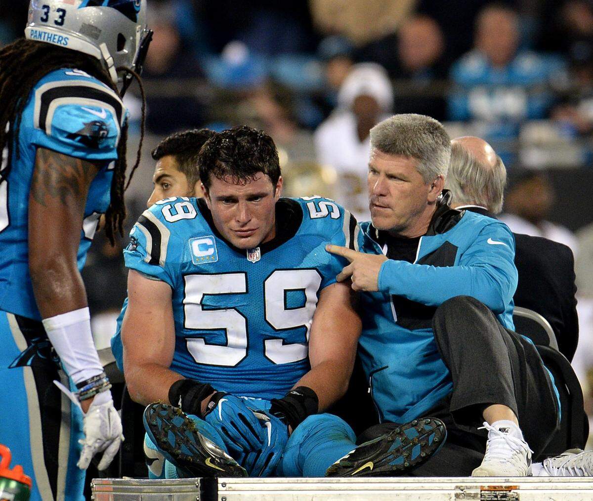 An emotional Luke Kuechly is driven off the field in a cart in 2016 after getting a concussion.