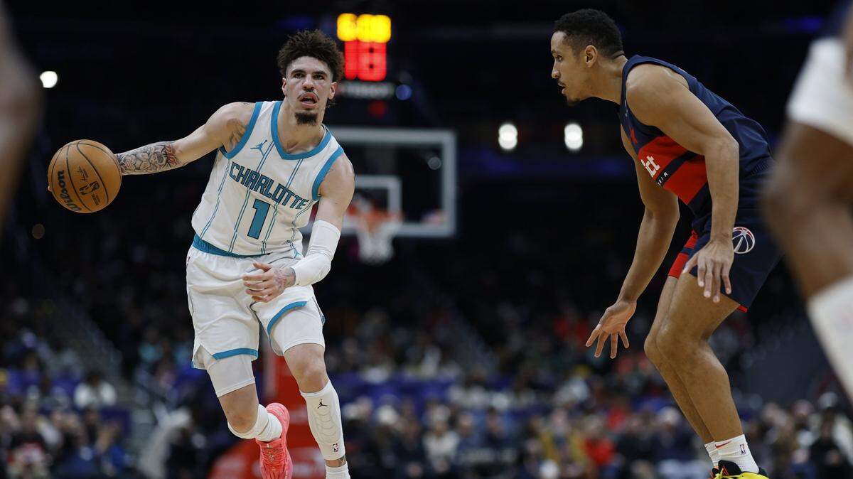 Charlotte Hornets guard LaMelo Ball (1) drives to the basket as Washington Wizards guard Malcolm Brogdon (15) defends in the second quarter at Capital One Arena.