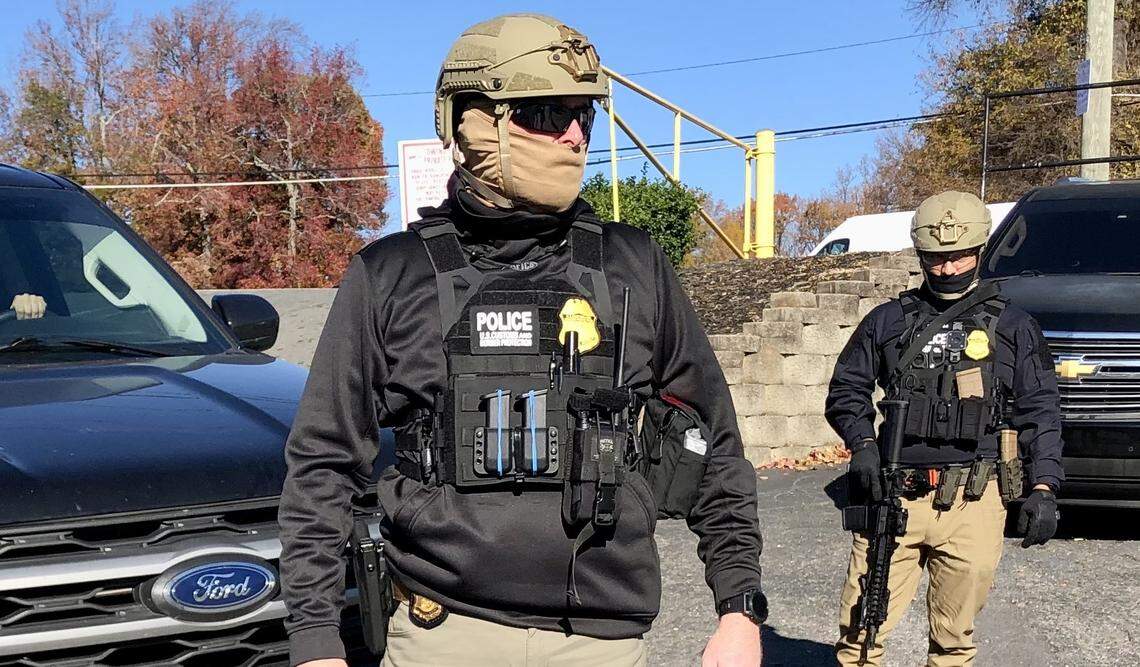 U.S. Customs and Border Patrol agents survey the parking lot of the Compare Foods on North Tryon St. in Charlotte, NC on Monday, November 17, 2025. 