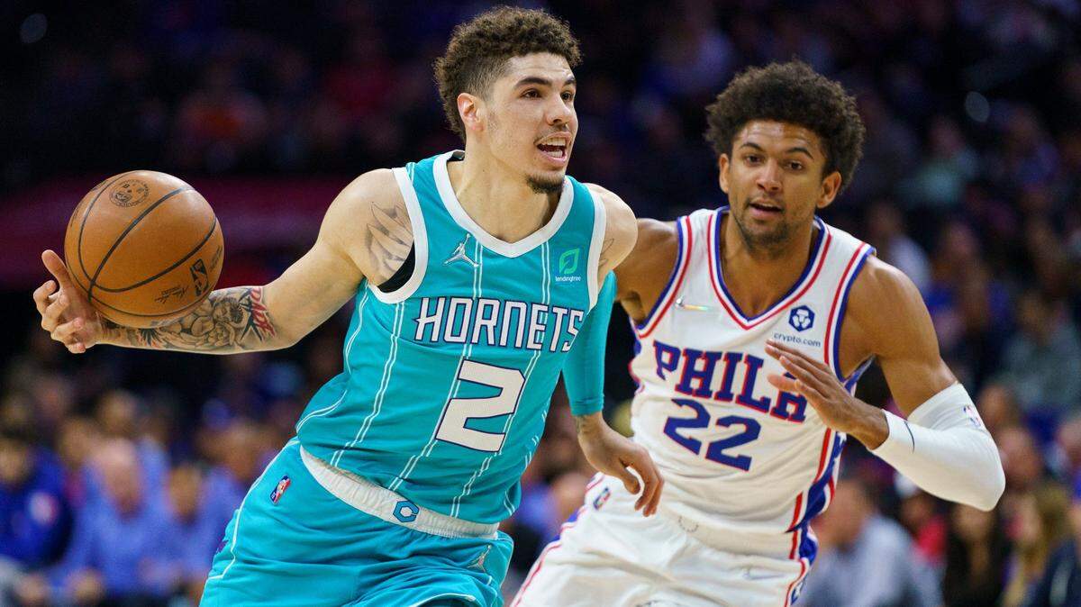 Charlotte Hornets’ LaMelo Ball, left, drives to the basket against Philadelphia 76ers’ Matisse Thybulle, right, during the first half of an NBA basketball game, Saturday, April 2, 2022, in Philadelphia. (AP Photo/Chris Szagola)