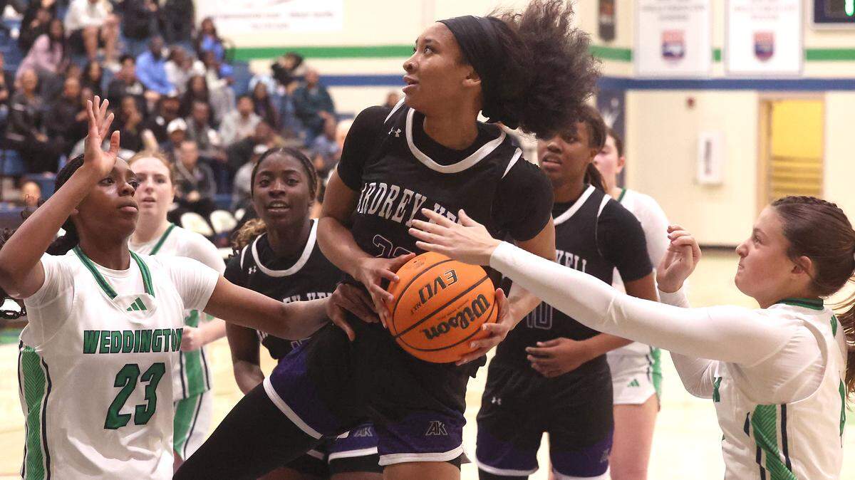 Ardrey Kell Knights Imani Shelton, center, fights to maintain control of a rebound as Weddington Warriors Myra Ukwu, left and Olivia Schultz, right, apply pressure during action on Tuesday, November 25, 2025 at Weddington High School.