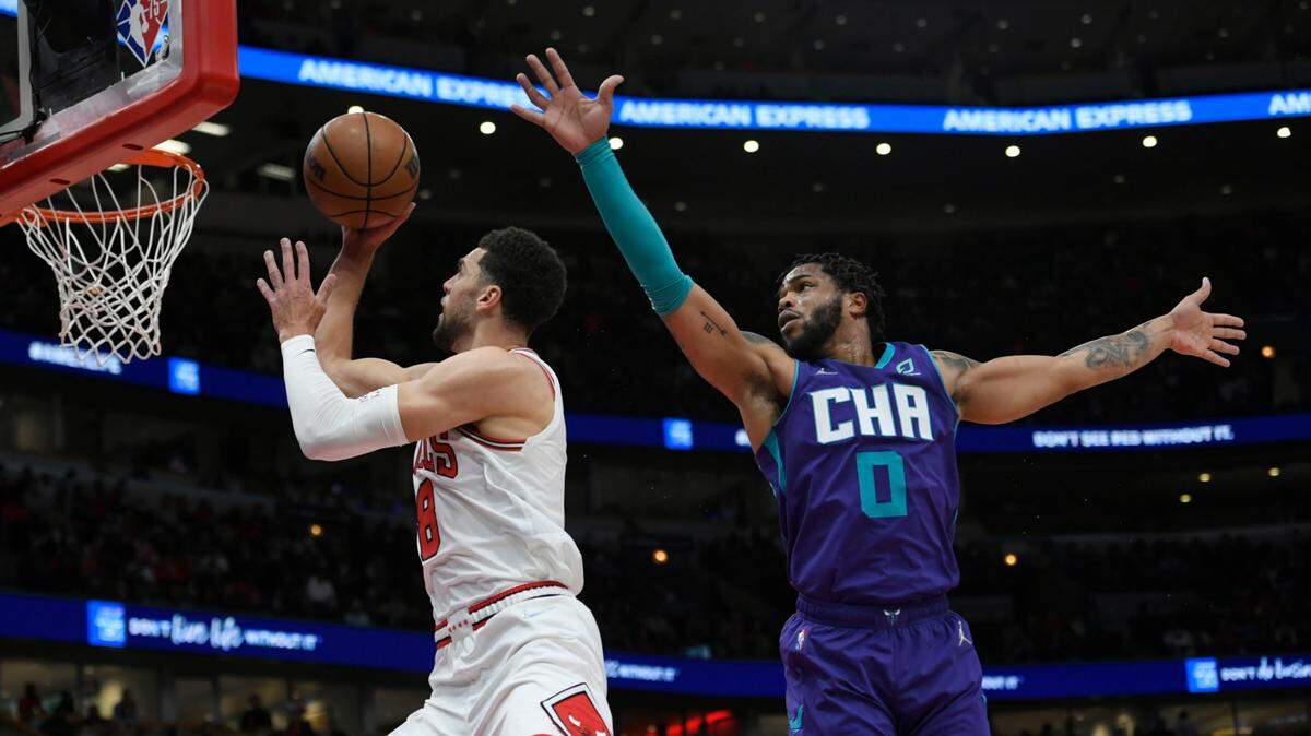 Chicago Bulls guard Zach LaVine (8) goes up for a shot against Charlotte Hornets forward Miles Bridges (0) during the first half of a NBA basketball game Monday, Nov. 29, 2021 in Chicago. (AP Photo/Paul Beaty)