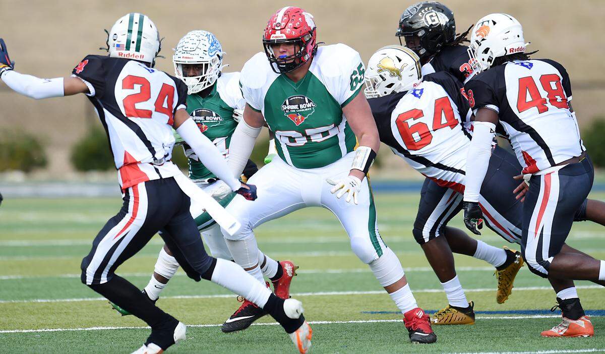 North Carolina’s Sullivan Absher (65) pass blocks. The Shrine Bowl of the Carolinas 86th annual Shrine Bowl Game was played at Spartanburg High School Saturday, December 17, 2022.GWINN DAVIS MEDIA 