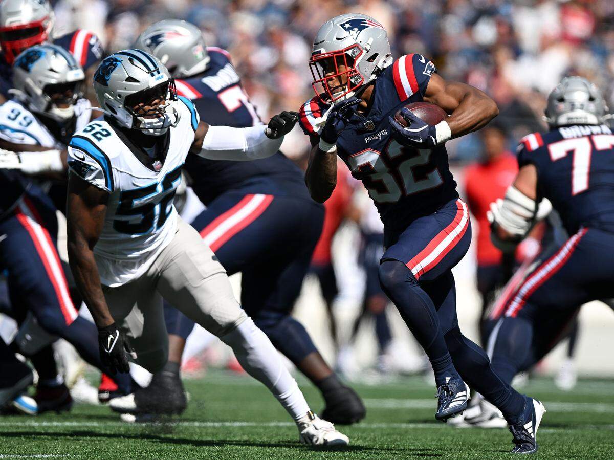 New England Patriots running back Treveyon Henderson (32) runs against the Carolina Panthers during Sunday’s first half at Gillette Stadium.