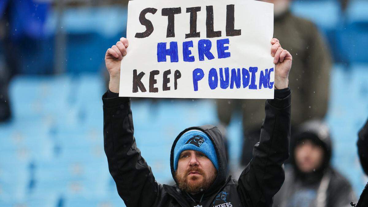 A Panthers fan holds a sign showing his support for the Panthers against the Falcons at Bank of America Stadium on Sunday, December 16, 2023.
