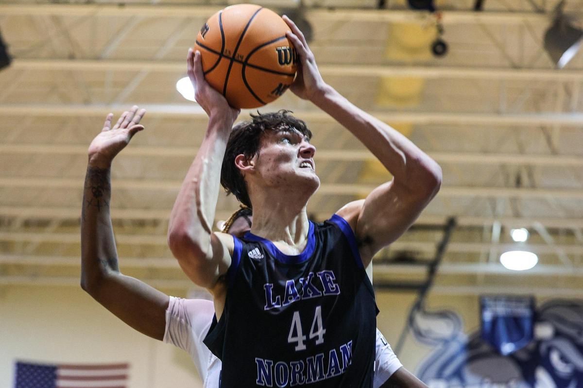 Lake Norman’s Trent Steinour (44) grimaces as he fights his way to the hoop during the game against Hickory Ridge on Thursday, January 25, 2024. Lake Norman defeated Hickory Ridge, 77-58.