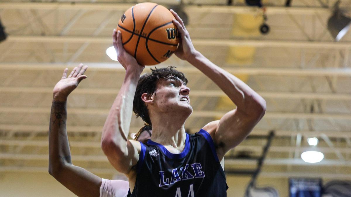 Lake Norman’s Trent Steinour (44) grimaces as he fights his way to the hoop during the game against Hickory Ridge on Thursday, January 25, 2024. Lake Norman defeated Hickory Ridge, 77-58.