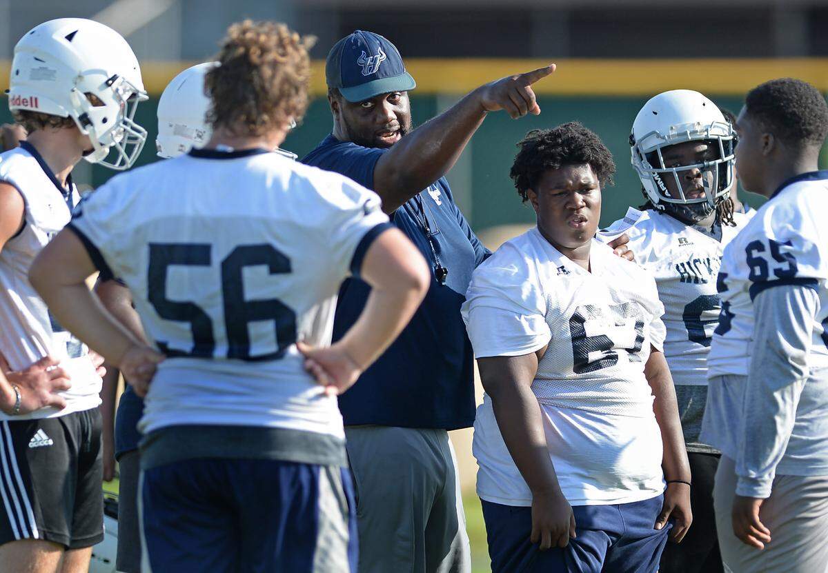Hickory Ridge High head football coach Jupiter Wilson, center, gives instructions to the offensive line on Tuesday, August 2, 2022.