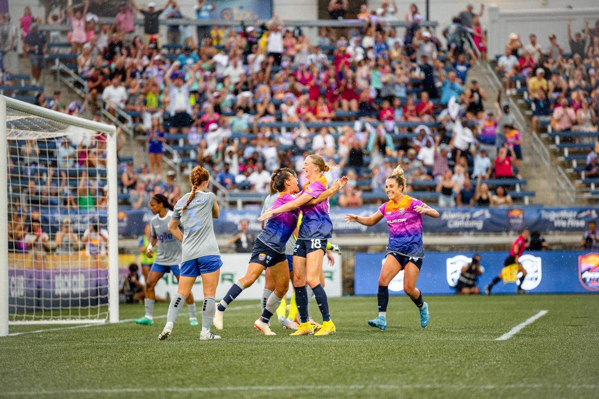 Members of the Carolina Ascent soccer club celebrate a goal by the Ascent’s Vicky Bruce, who scored the first goal in the history of the club — and the USL Super League.