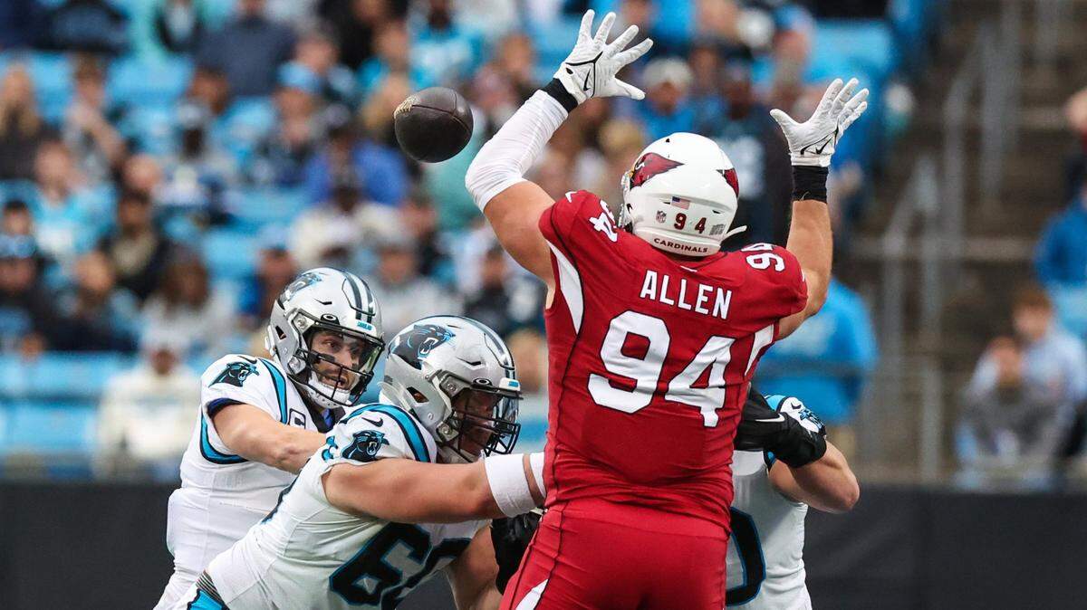 Cardinals defensive lineman Zach Allen, right, stretches out to block a pass by Panthers quarterback Baker Mayfield during the game against the Cardinals on Sunday, October 2, 2022, 2022 in Charlotte, NC. The Panthers lost 26-16.
