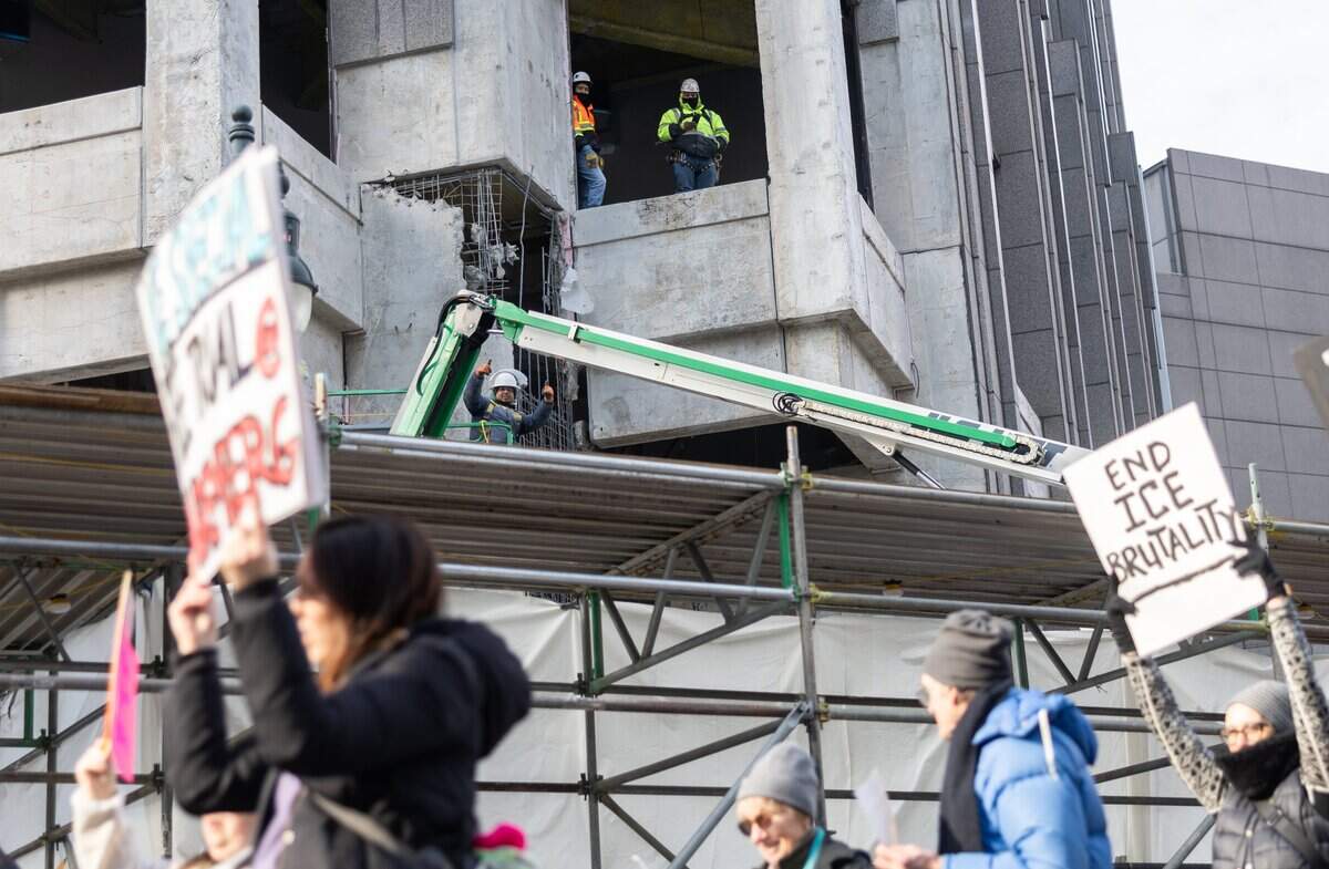 Construction workers wave at protesters during the ICE OUT Charlotte: Stand with Minnesota Rally in Charlotte, N.C., on Friday, January 30, 2026.