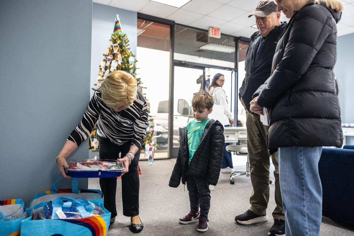 A family drops of supplies to make birthday cakes at Bridge of Hearts in Mooresville, N.C., on Tuesday, December 9, 2025. The organization annually provides birthday gifts and health and hygiene kits to about 1,000 unhoused and impoverished children, and nursery items to pregnant teens.