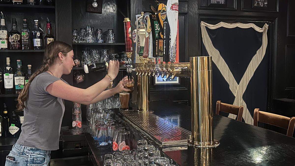 Andie Hollis pours a beer at Sir Edmond Halley’s.