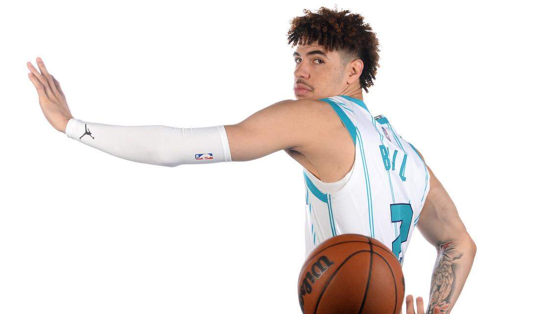 Charlotte Hornets guard LaMelo Ball throws a behind-the-back pass during a photo session at media day on Monday. Ball was the NBA’s Rookie of the Year last season.