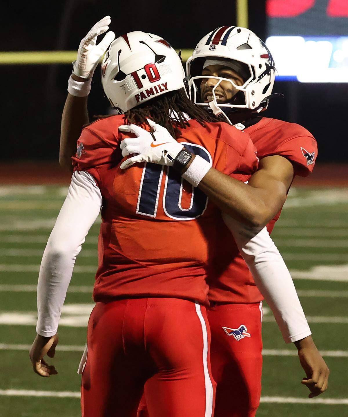 Providence Day Chargers quarterback Zaid Lott, left, receives a hug from wide receiver Gordon Sellars, right, following a touchdown during action against the Charlotte Christian Knights in the NCISAA D1 state championship game on Friday, November 21, 2025. Providence Day defeated the Charlotte Christian Knights 42-6.
